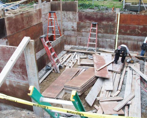 During Adding a new foundation to create a full height basement, add onto home Seattle