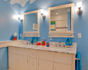 A seaside motif for the kids bathroom remodel.  Pottery Barn cabinets with marble countertops and lots of color make this a great bathroom to share, kids bath Seattle