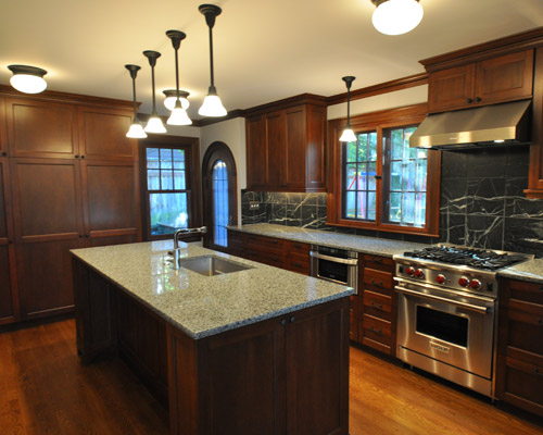 The area behind the old stove was a full bath. By removing that, new cabinets are closer to the rear wall, opening up additional floor space for a full wall of pantry cabinets. seattle house awards best renovations