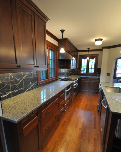 By removing the wall and expanding into that area, there is room for ample cabinetry and an island. Kitchen addition Seattle