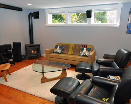 The work started with a revamp of the media room.  By adding windows, the room is now filled with light during the day, and a comfortable screening room at night.  To complete this work, the foundation and pony wall were retrofitted and the walls furred out accept insulation.  That also provided the opportunity to wire for a complete projection and speaker system for the media room.  Previously wires had been tacked to the walls